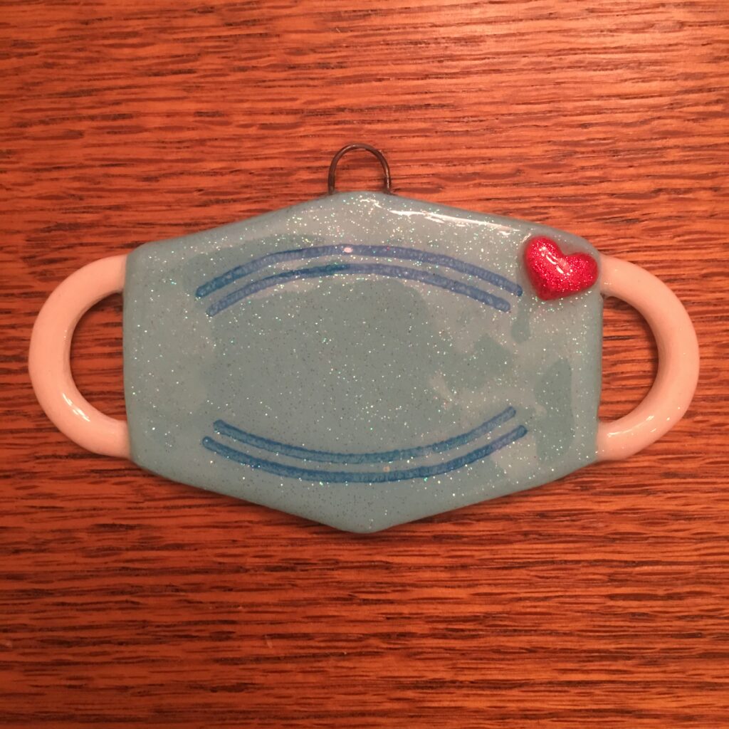 A blue mask with a red heart on it.