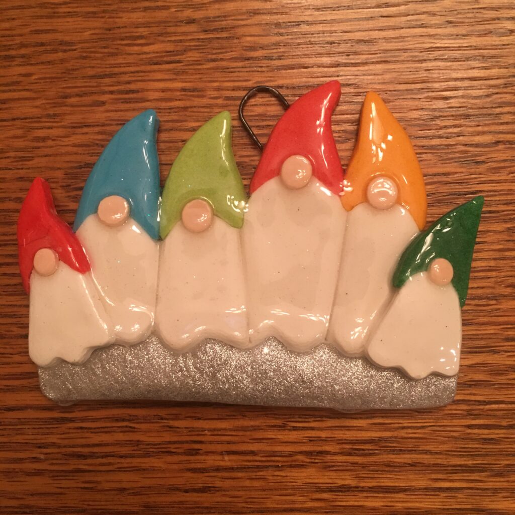 A group of five gnomes are sitting on the table.