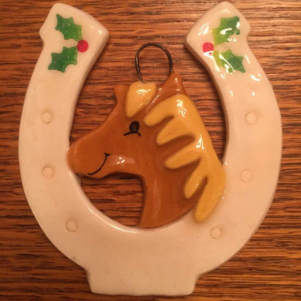 A horse ornament hanging on the wall.