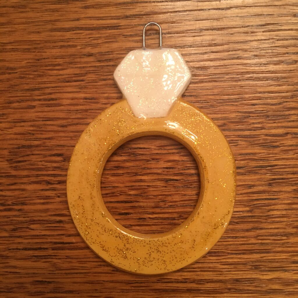 A wooden ring with a diamond on it.