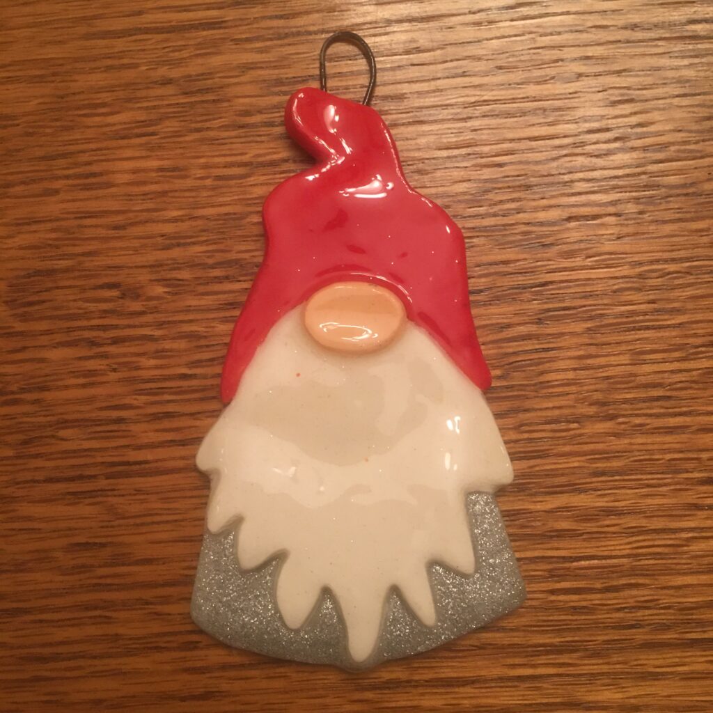 A gnome ornament is sitting on the table.