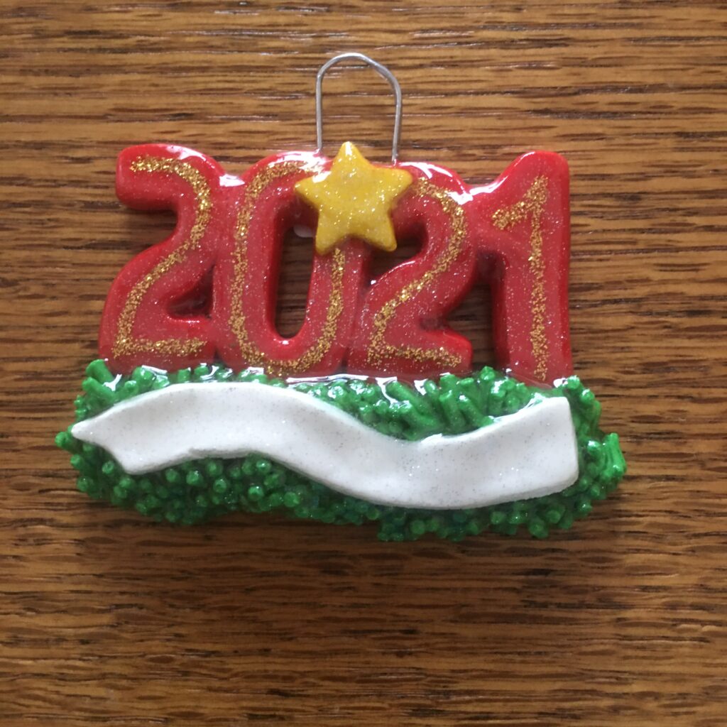 A red and green ornament with the number 2 0 2 1.