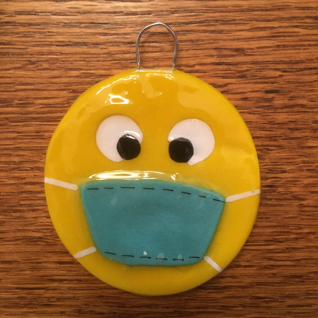 A yellow face with a blue mask on it.