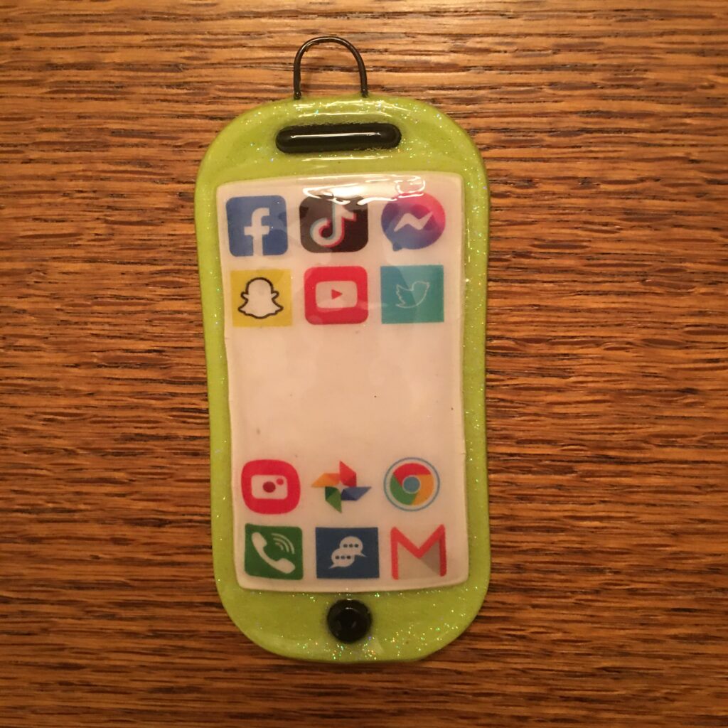 A green cell phone with many icons on it.