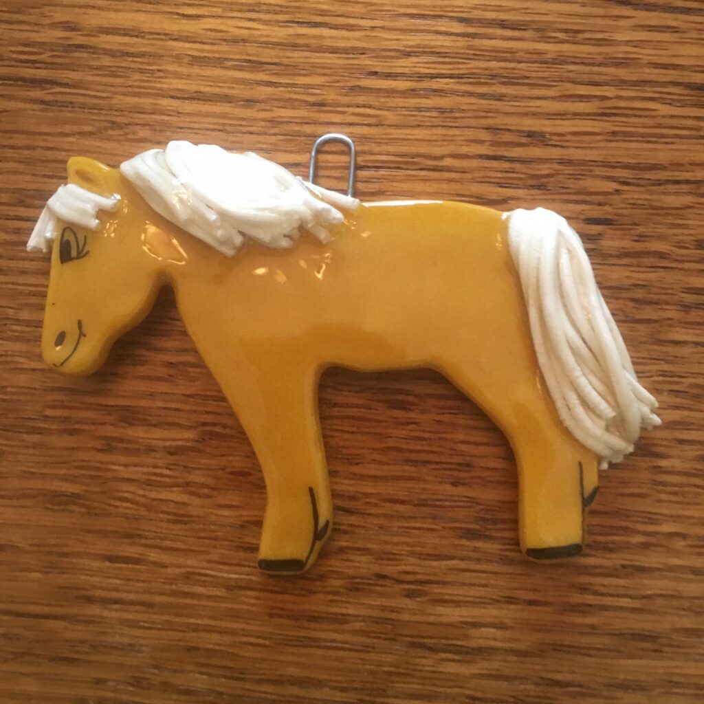 A yellow horse with white mane and tail.