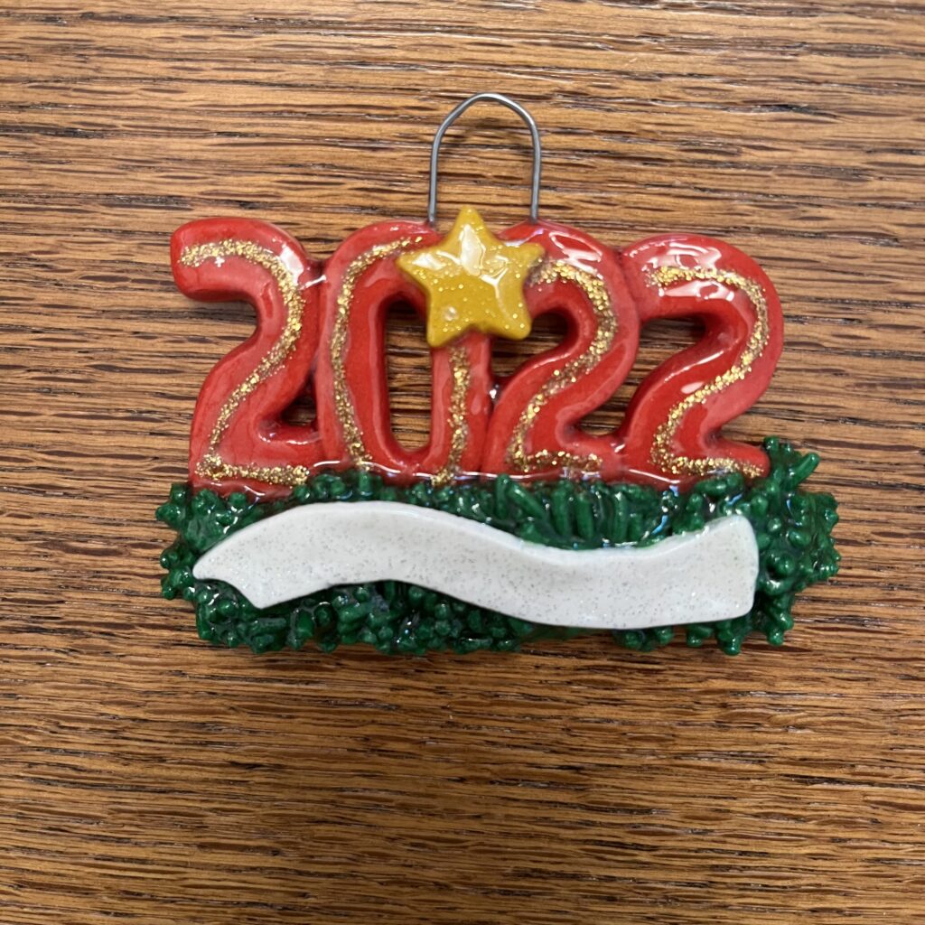 A red and gold ornament with the number 2 0 2 2 on it.