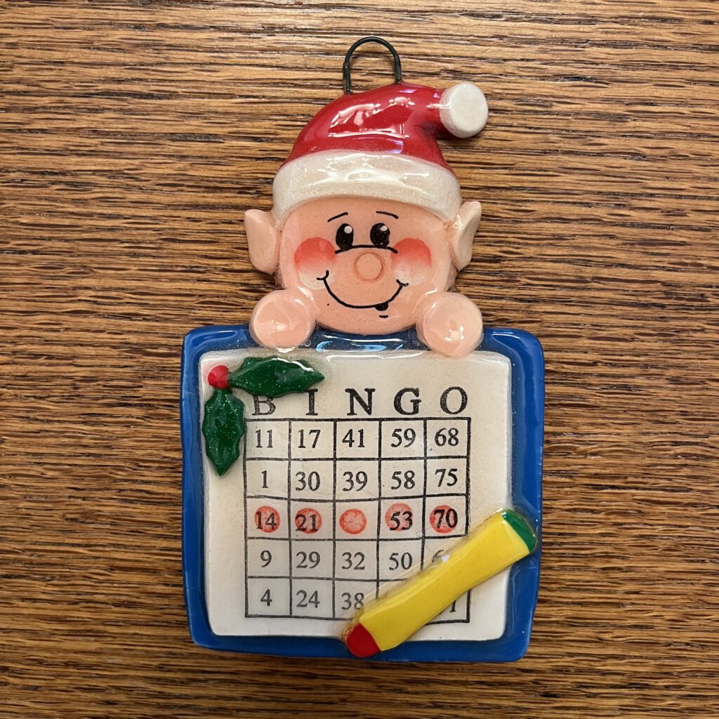 A christmas ornament with an elf on it.