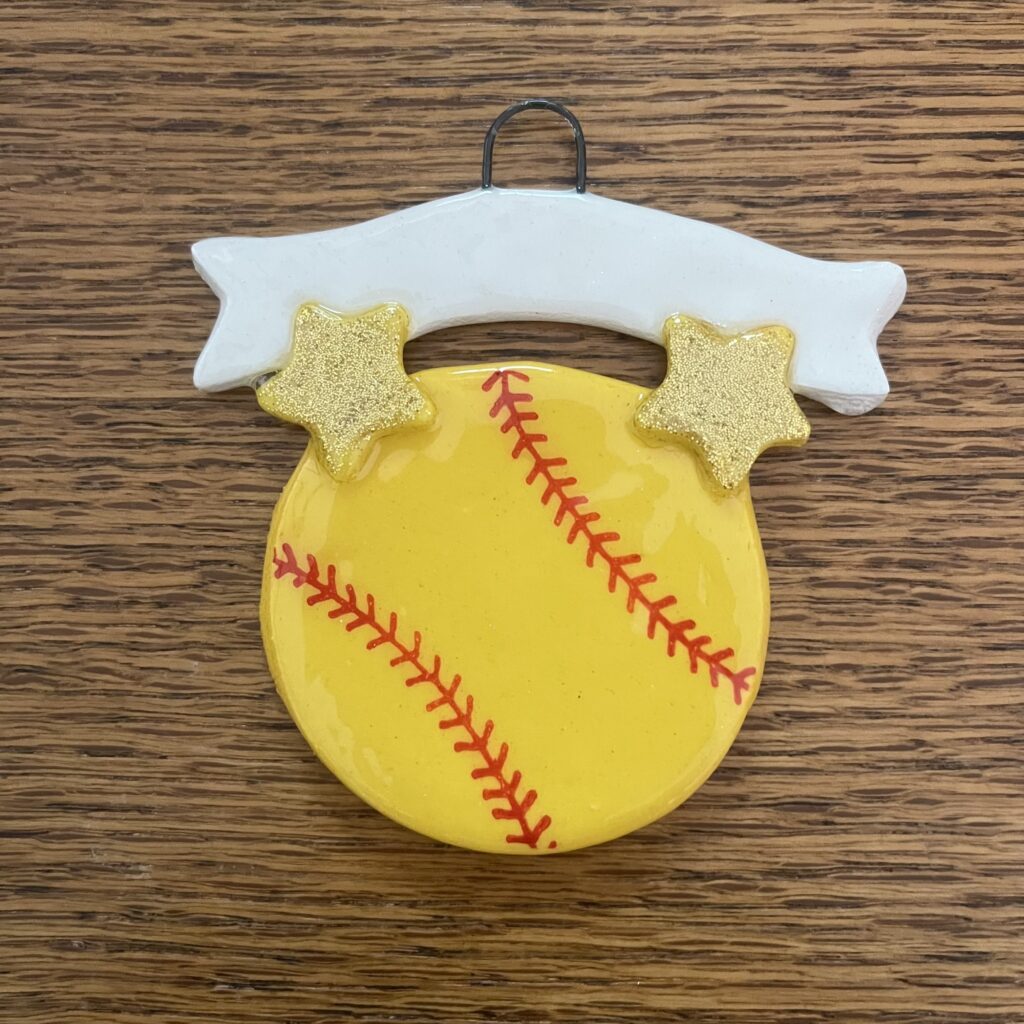 A softball ornament with two stars and a banner.