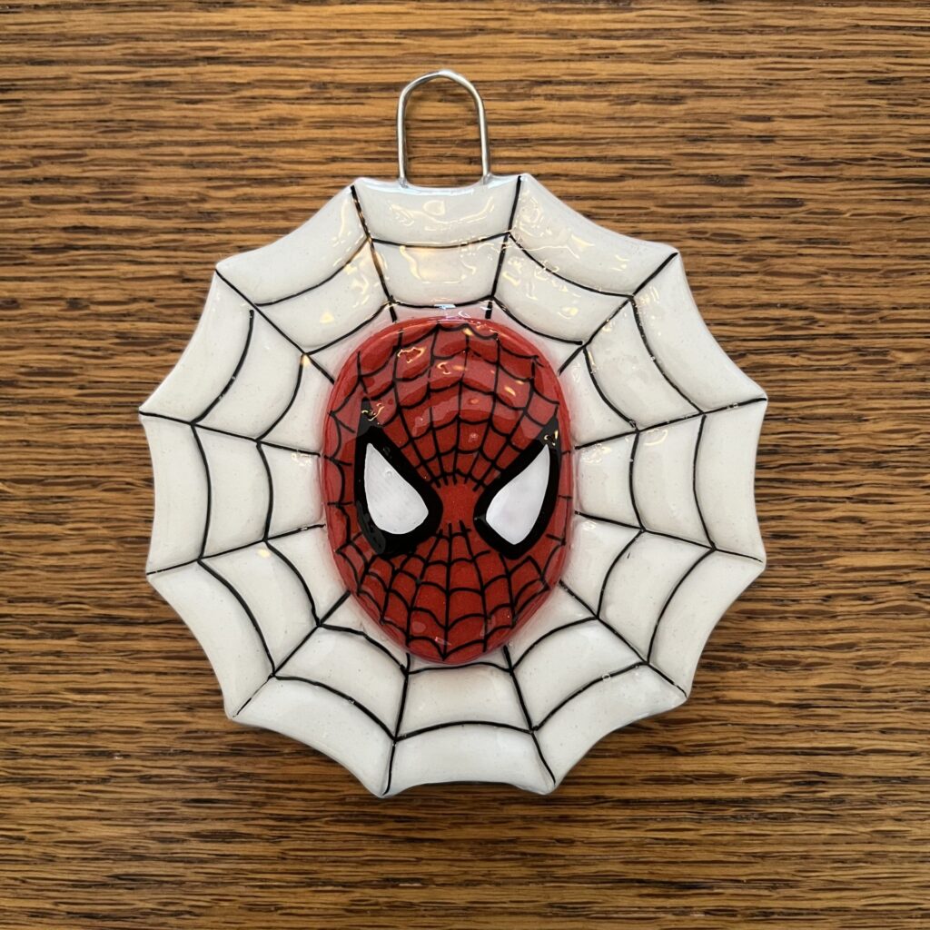 A spider-man mask hanging on the wall.